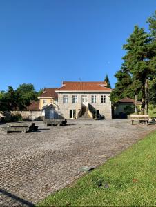 a large house with benches in front of it at Casas do Souto in Lousada