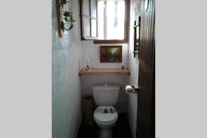 a small bathroom with a toilet and a window at Demi villa à 150m de la plage avec vue sur mer in Appietto +7 photos