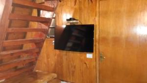 a flat screen tv on a wall in a room at Chalé - Sossego 1 in Campos do Jordão +7 photos