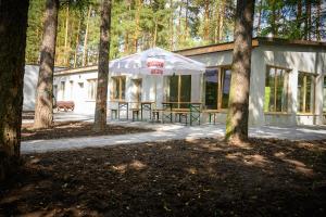 a building with a tent in the middle of trees at Borowik Milicz in Milicz