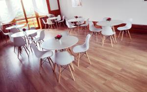 a group of tables and chairs in a room at Pensjonat Zacisze in Czchów