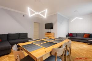 a living room with a table and a couch at Apartment Nearto Old Town Daszyńskiego street in Krakow