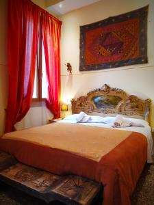 a bedroom with a large bed with red curtains at B&B Venice 1964 in Venice