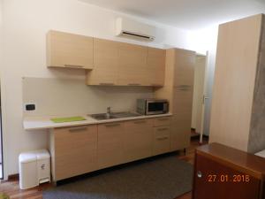 a small kitchen with a sink and a microwave at Cosy Central Flat in Bergamo