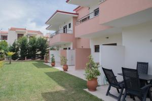 un patio de una casa con sillas y mesa en Villa Valerie, en Nikiti