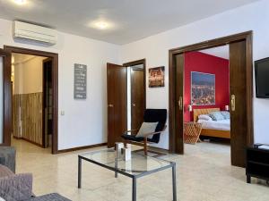 a living room with a coffee table and a bedroom at La Pedrera Residence in Barcelona