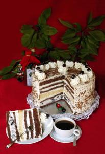 a cake sitting on a table with a cup of coffee at Waldgasthof Altersbach in Waldkirch