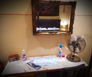 a room with a table with a fan and a mirror at B&B Venice 1964 in Venice