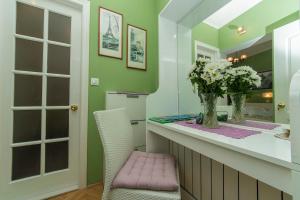 a bathroom with a counter with a pink chair at Villa Palma Apartments in Makarska