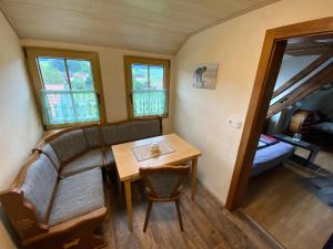 a small dining room with a table and a couch at Ferienwohnung Eva und Alexander in Hirschbach