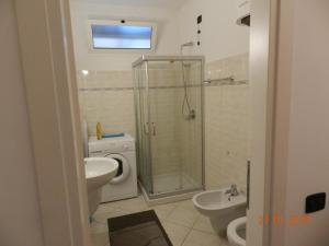 a bathroom with a shower and a sink and a toilet at Cosy Central Flat in Bergamo