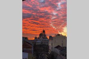 a sunset in the city with a red sky at Studio 13 in Varna City