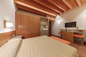 En eller flere senge i et værelse på Pecora Vecchia - ColleMassari Hospitality