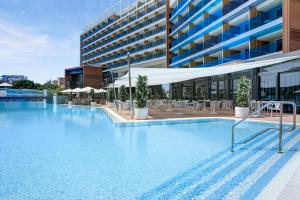 a large swimming pool in front of a building at Almar Jesolo Resort & Spa in Lido di Jesolo