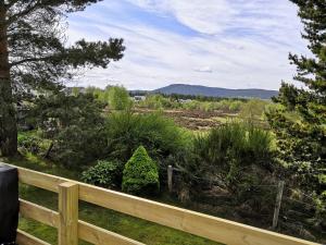 a view of a garden from a fence at Bynack Lodge in Boat of Garten