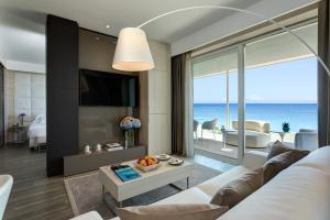 a living room with a white couch and a view of the ocean at Almar Jesolo Resort & Spa in Lido di Jesolo