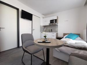 a small room with a table and a bed at HP Apartments in Neu-Ulm