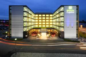 a building with a large sign on the side of it at Holiday Inn Express Zürich Airport by IHG in Rümlang