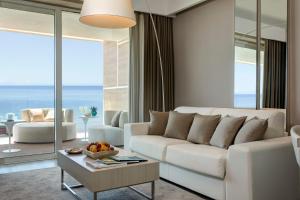 a living room with a white couch and a table at Almar Jesolo Resort & Spa in Lido di Jesolo