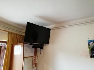 a flat screen tv hanging on a wall at House Osana in Grabovac