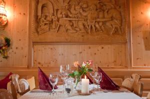 a table in a restaurant with a carving on the wall at Hotel Gasthof Neuwirt in Holzkirchen