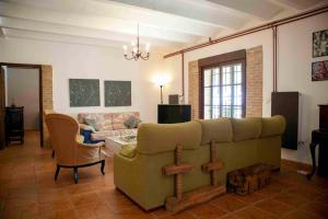 a living room with a couch and a table at Caserío Lo Bulle in Oria
