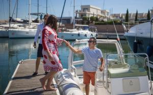 a man and a woman standing on a boat at Marina di Scarlino Resort in Puntone di Scarlino