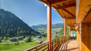 a balcony of a cabin with a view of a valley at Les Pins - Apt 11 - BO Immobilier in Châtel