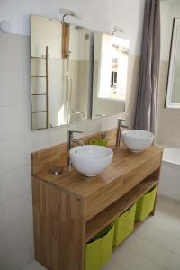 een badkamer met 2 wastafels en een spiegel bij Gîte L'oliveraie d'Aniane 7 personnes in Aniane