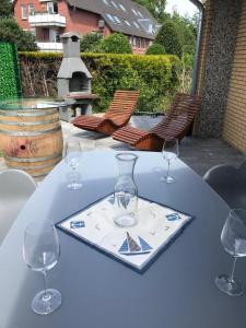 a white table with wine glasses on top of it at Haus Bachwiesen in Grömitz