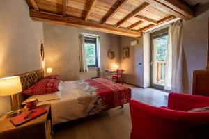 a bedroom with a bed and a table and chairs at La Stazione dell'Acqua in Introd