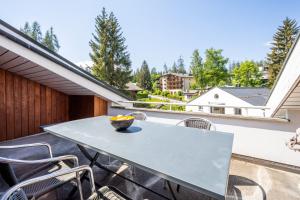 a patio with a table and chairs on a balcony at Casa Alva - FLIMS in Flims