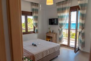 a bedroom with a bed and a view of the ocean at Dimi Seafront Apartment by Rentals Pro - Nea Moudania in Nea Moudania