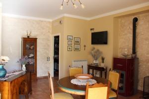 a living room with a table and a dining room at La Sorgente Del Sole in San Severino Marche