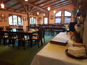 a dining room with tables and chairs in a restaurant at Hotel Starý Mlýn in Mlýnec +37 photos