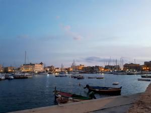 a harbor with boats in the water at night at Lakkios charming suites and rooms in Syracuse