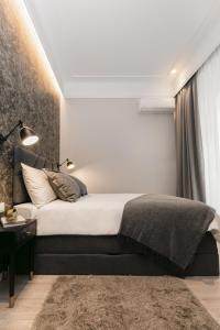 Schlafzimmer mit einem Bett mit einem schwarzen Kopfteil in der Unterkunft Harbour Residence Apartments in Rijeka
