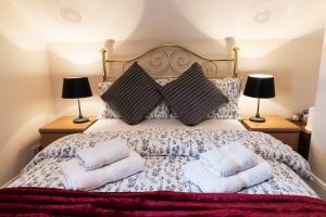 a bedroom with a bed with two towels on it at Princetown Guesthouse in Bangor