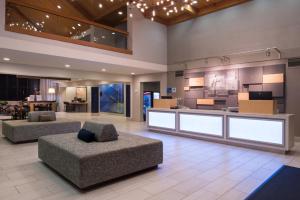 a lobby with two couches and a bar in a building at Holiday Inn Express Walnut Creek, an IHG Hotel in Walnut Creek