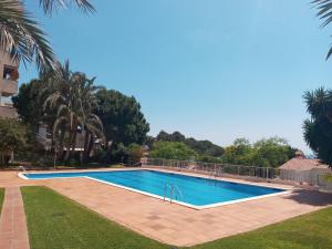 a swimming pool in the middle of a yard at Palma Fiesta Apartment by Hello Homes Sitges in Sant Pere de Ribes +25 photos