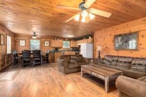 a living room with a couch and a ceiling fan at Tennessee Lodge in Sevierville