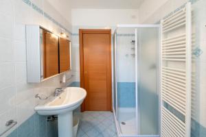 a bathroom with a sink and a shower at Marina Apartment in San Benedetto del Tronto