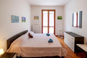 a bedroom with a bed with two shoes on it at Marina Apartment in San Benedetto del Tronto