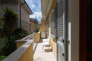 a balcony with two chairs on a building at Marina Apartment in San Benedetto del Tronto