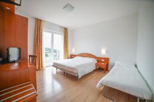 Postel nebo postele na pokoji v ubytování Hotel Nuova Barcaccia