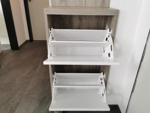 a shelf with white drawers in a room at HP Apartments in Neu-Ulm