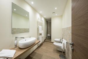 a bathroom with two sinks and two toilets at Hotel Marelet in Treviglio