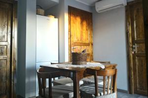 a kitchen with a table and chairs and a refrigerator at Corona Bed & Breakfast in Sardara