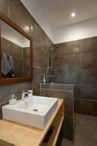 a bathroom with a white sink and a mirror at Maison Tavolara in Porto-Vecchio +41 photos