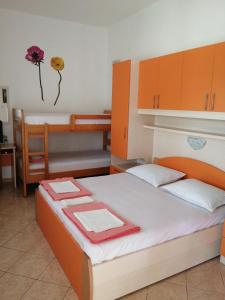a bedroom with a bed with a flower on the wall at Apartmani nana in Starigrad-Paklenica